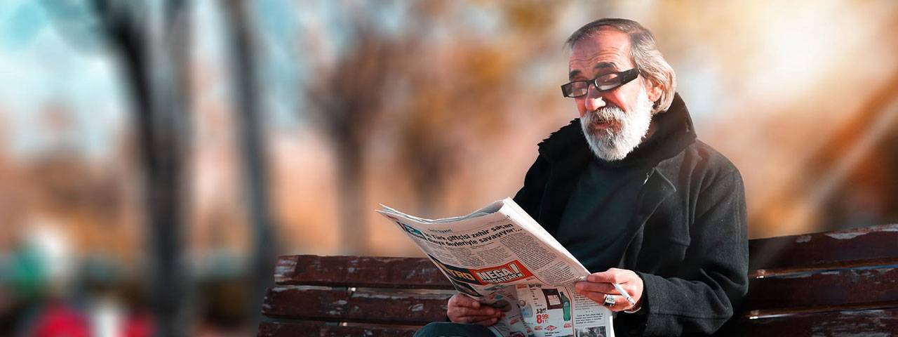 Fuchs Corneal Dystrophy patient reading newspaper